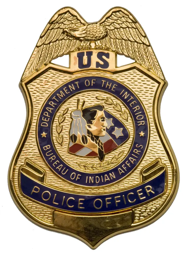 A gold Bureau of Indian Affairs police officer badge