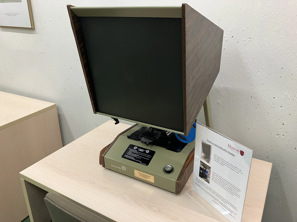 A microfilm reader on a library desk