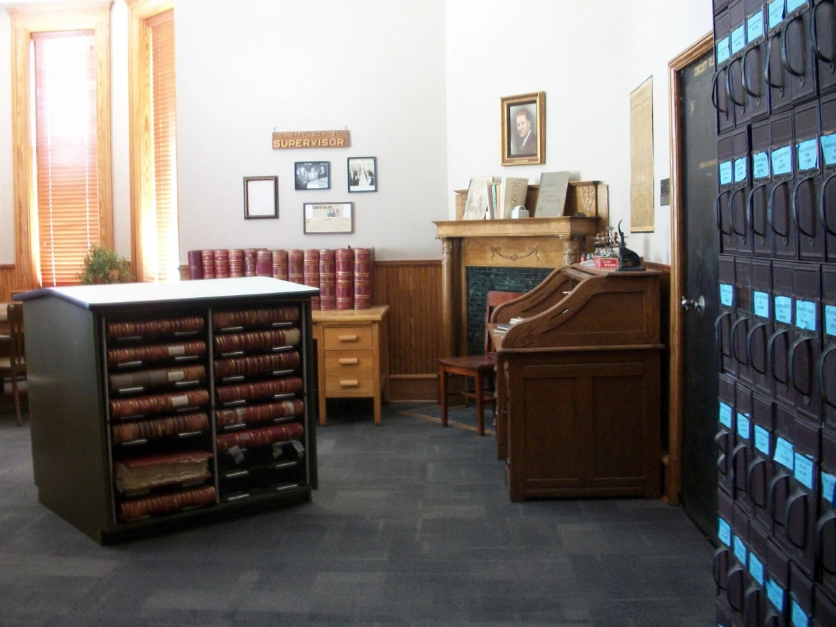 Rows of bound record books in a county courthouse records room