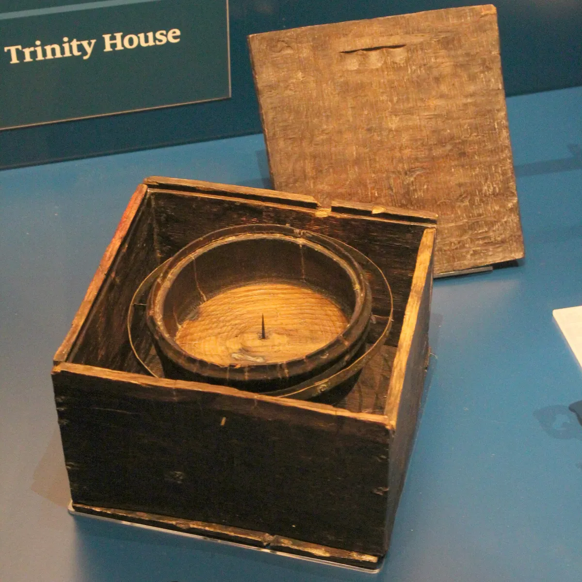 An old ship's compass in a wooden box