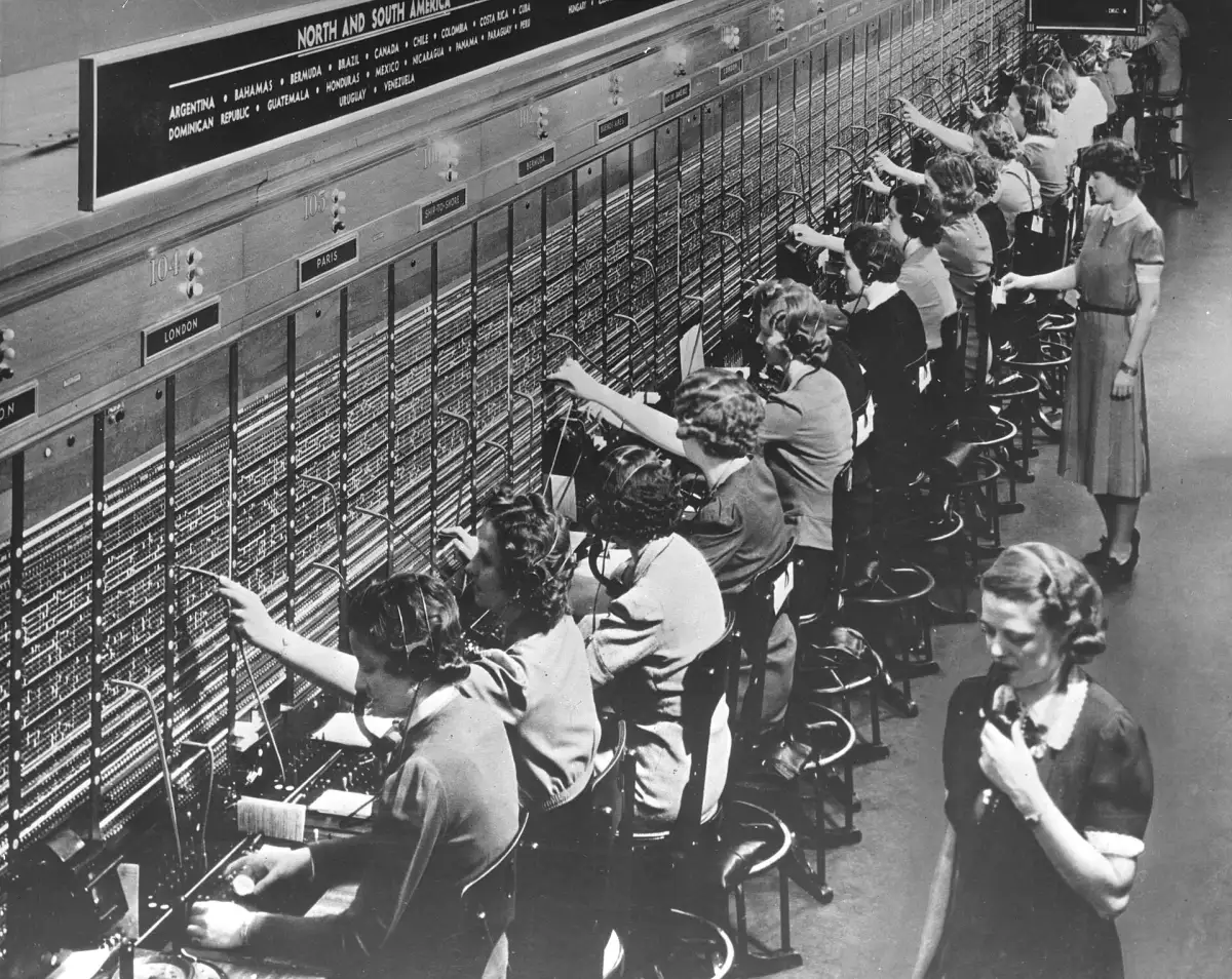 Rows of telephone operators working at a Bell System switchboard