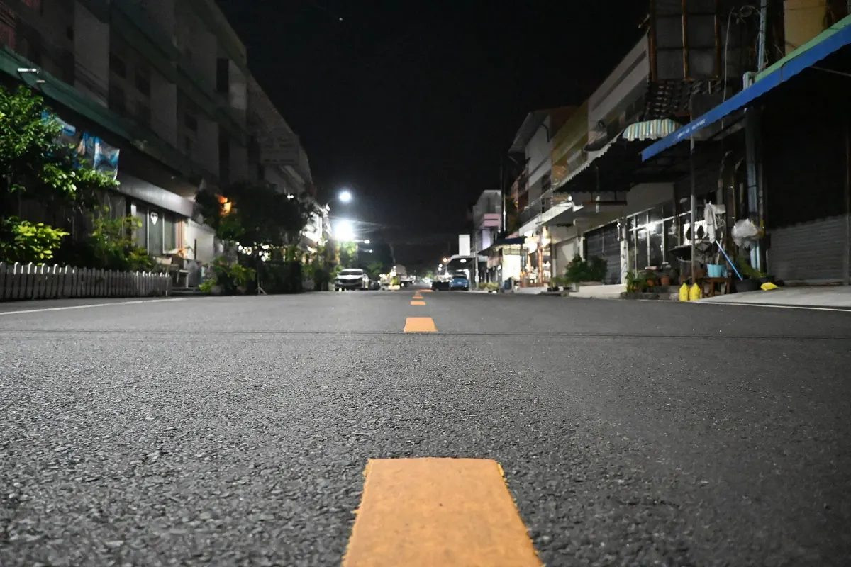 An empty street at night lit by streetlights